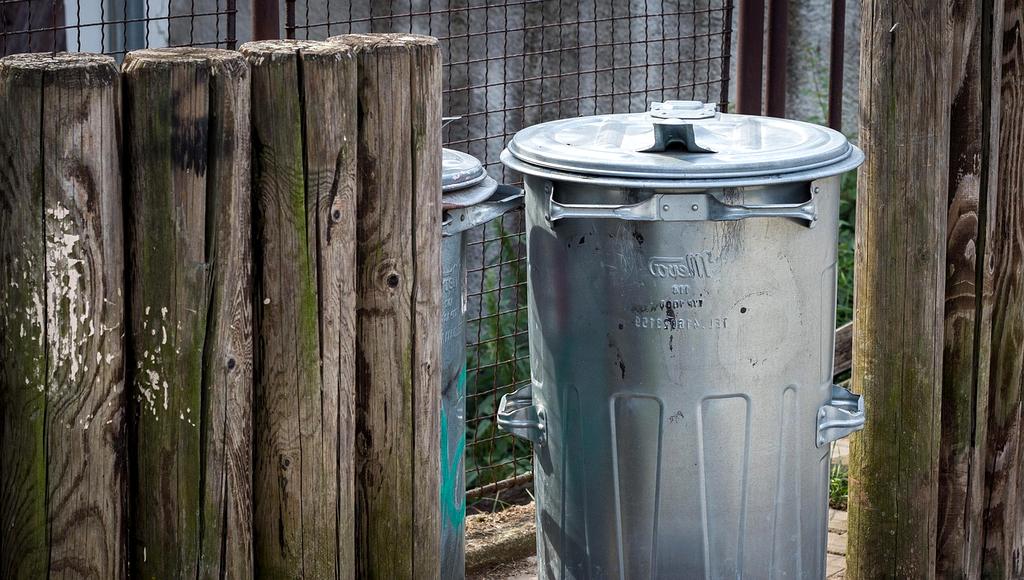 Family sorting household waste into different containers